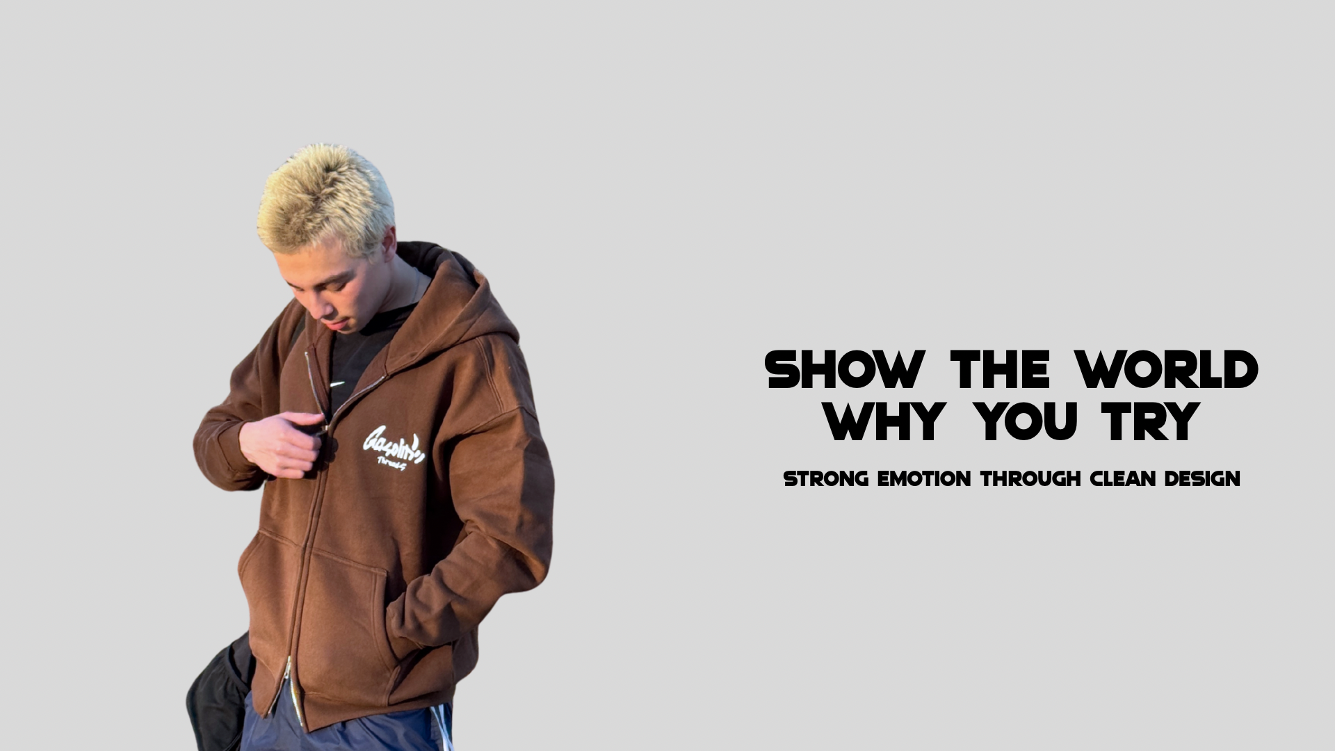 Person wearing a brown hoodie with text on a gray background